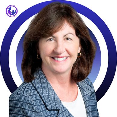 Professional woman smiling with a blue patterned blazer and hoop earrings.