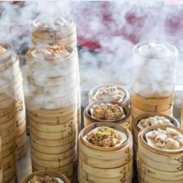 Assorted Cantonese dim sum served in traditional bamboo steamers.