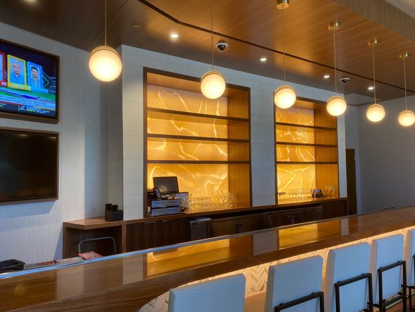 Modern bar with warm lighting and pendant lamps.