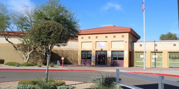 Exterior view of a school building with blue sky.