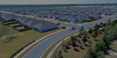 Aerial view of a suburban neighborhood with many houses and roads.