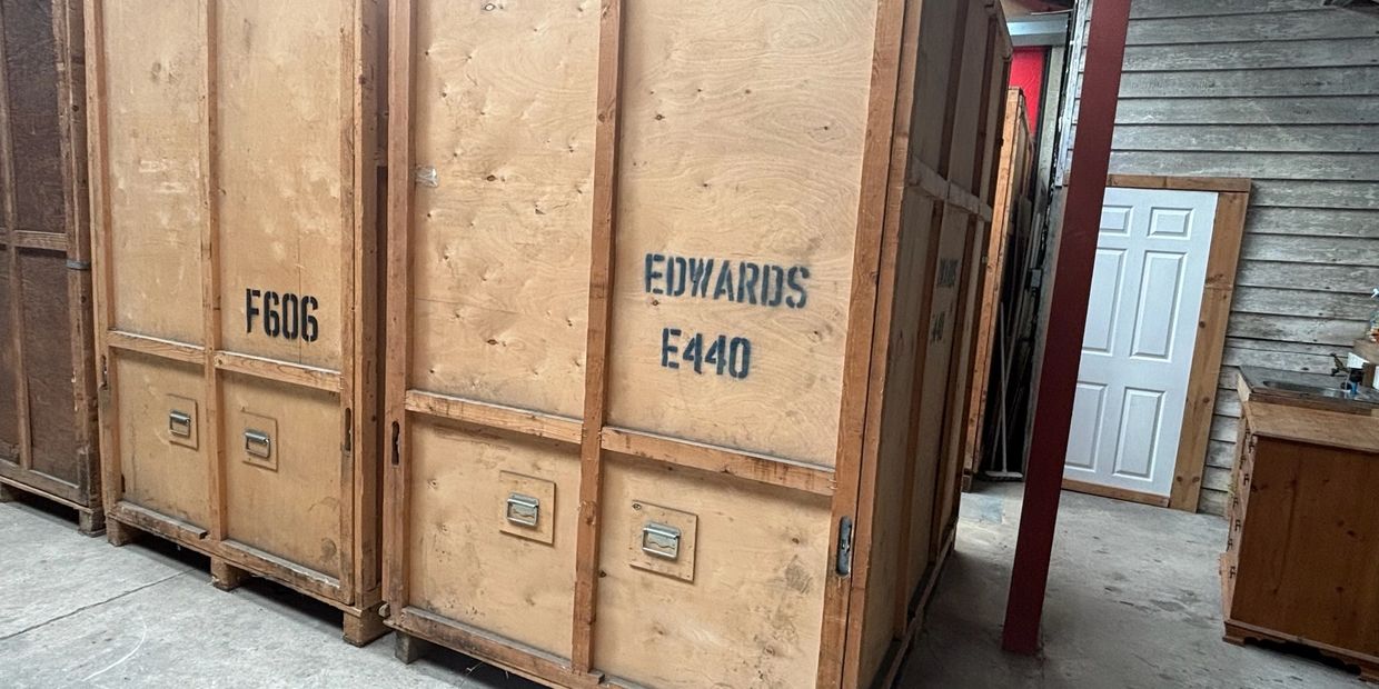 Wooden crates with labels in a storage area.