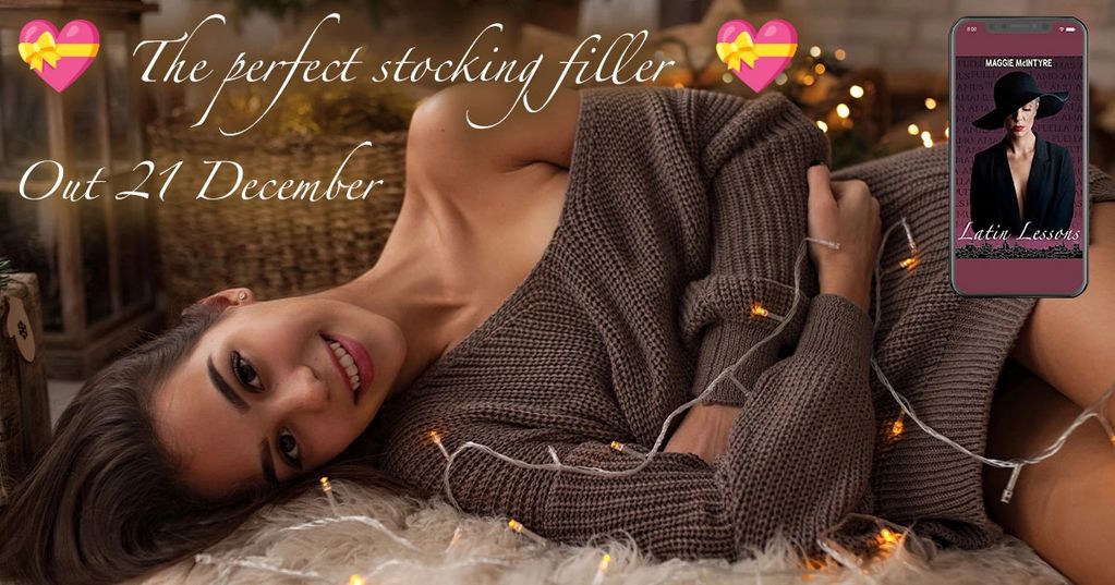 Image of beautiful woman lying on furry white rug. She holds a string of Christmas lights.
