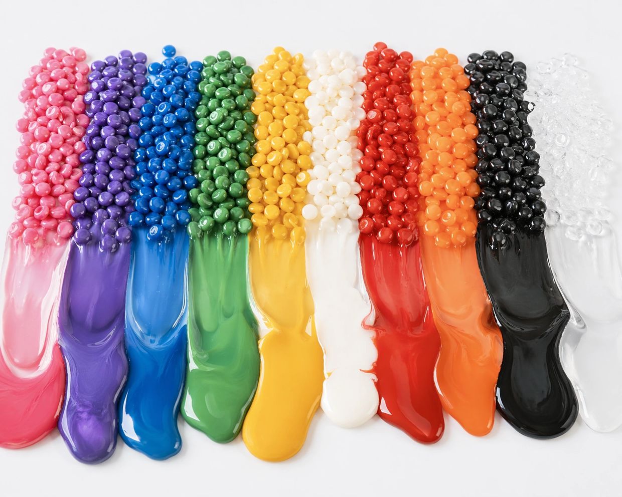 Different colored hard wax beads for hair removal arranged side by side in rows by color