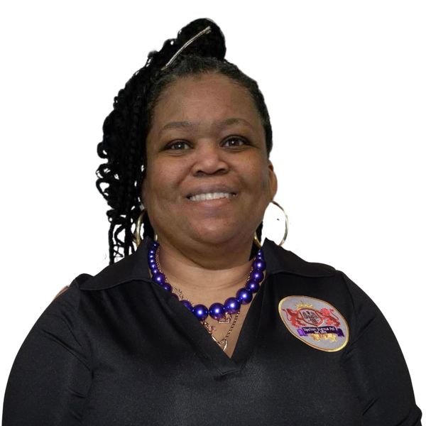 Smiling woman in black shirt with purple bead necklace and hoop earrings.