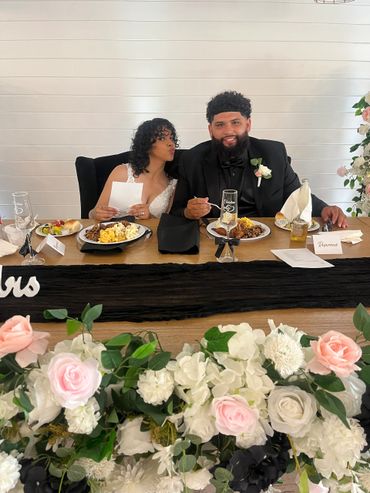 Newlywed couple sharing a joyful moment at their wedding reception.