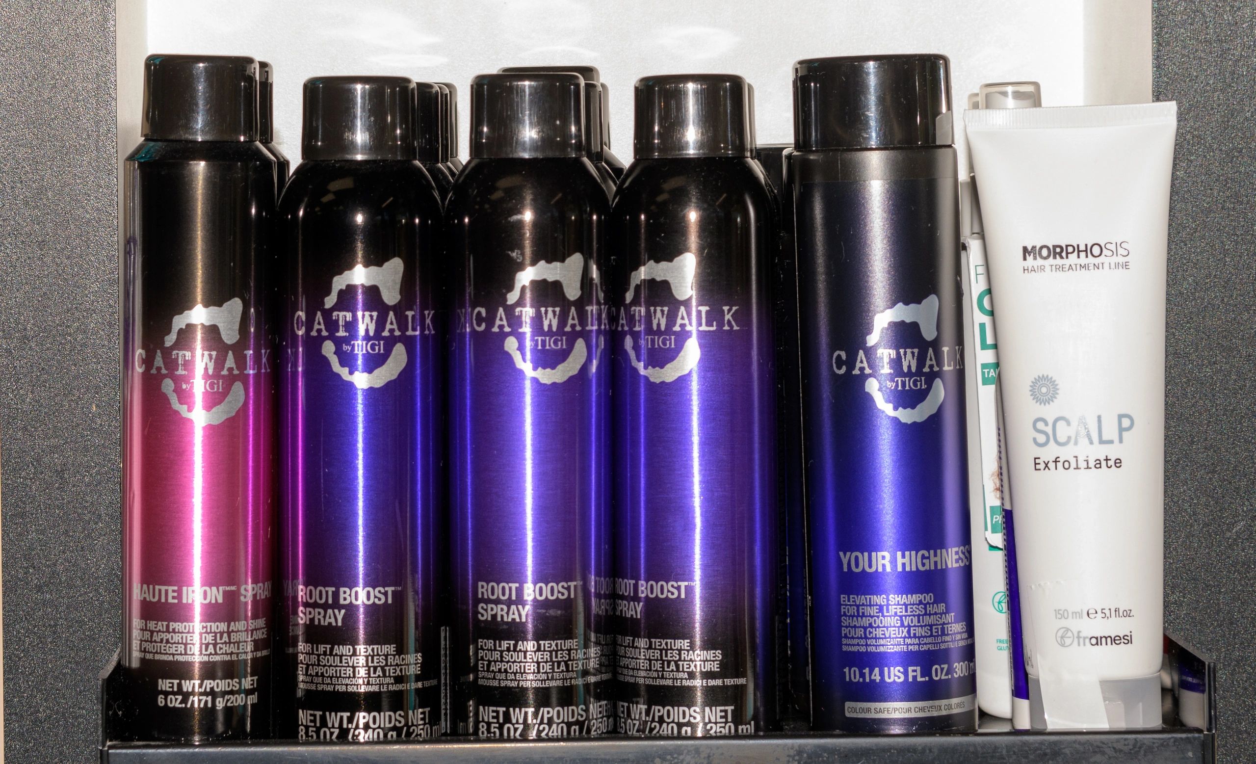 Hair care products including Catwalk by TIGI sprays and Morphosis scalp exfoliate.