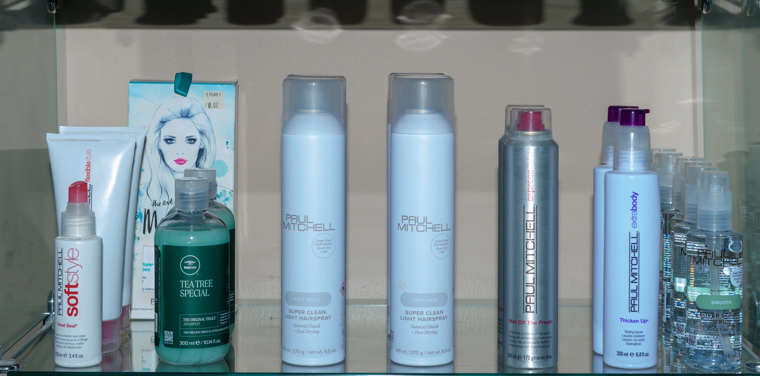 Various Paul Mitchell hair care products neatly arranged on a shelf.