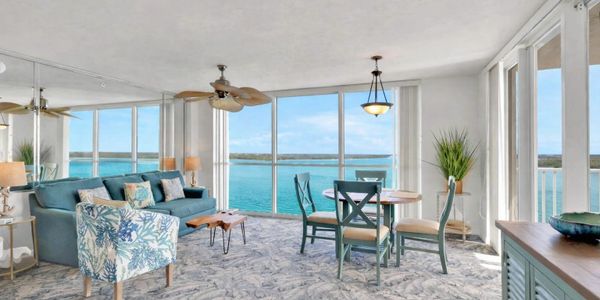 Bright living room with ocean view and stylish furniture.