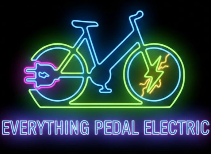 Neon sign of an electric bike with the text 'Everything Pedal Electric'.
