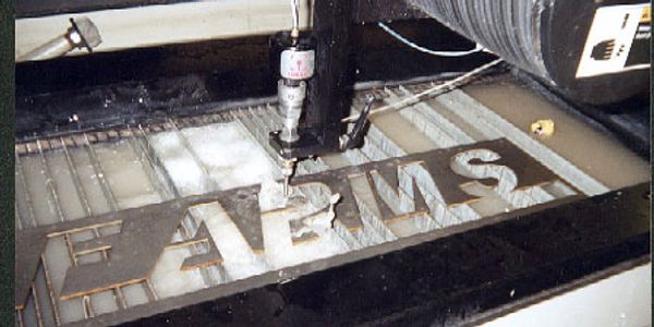 Waterjet cutting custom signs on the OMAX waterjet.  
