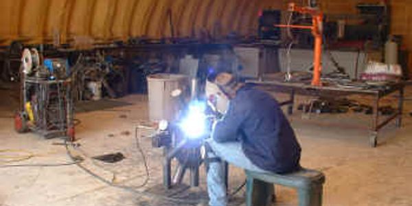 Welding and Metal Fabrication.  Flux cored arc welding in progress by me.
