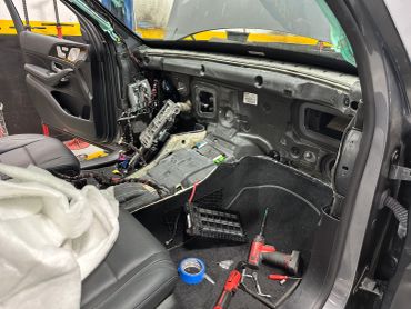 Car interior stripped down for repairs or modification.