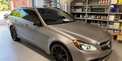 Matte gray Mercedes-Benz station wagon in a garage.