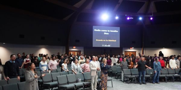 Congregation gathered in a church for worship and praise.