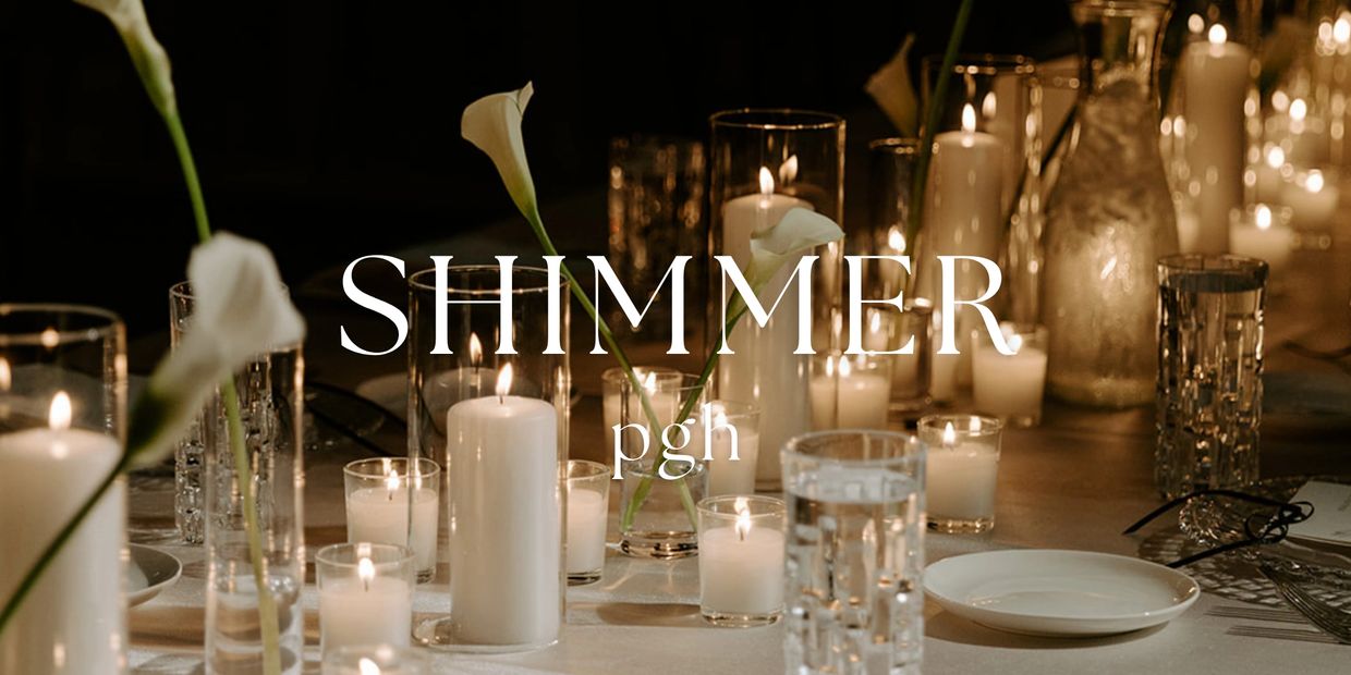 Elegant candlelit table setting with flowers.