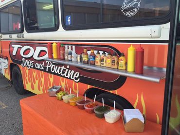 A close-up view of Todd's Dogs condiment table