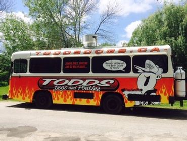 The side view of Todd's Dogs original food truck stationed at Roth Park in Woodstock, Ontario