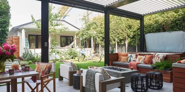 Cozy outdoor patio with seating and greenery.