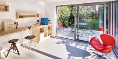 Bright modern workspace with large sliding glass doors opening to garden.