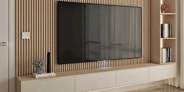 Modern living room with wall-mounted TV and wooden slat accent wall.
