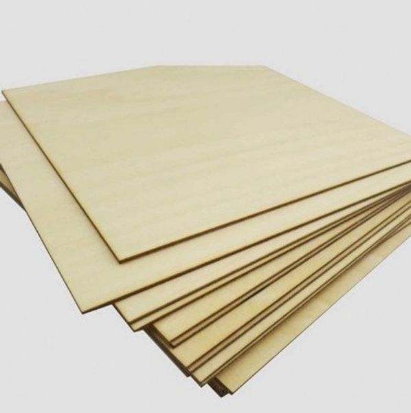 Picture of a bundle of basswood plywood before it is prepared for the laser and then laser engraved.