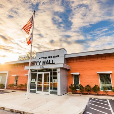 City Hall building of Red Bank under a partly cloudy sky.
