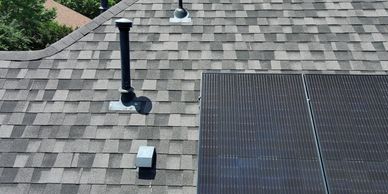 Close up of home roof and solar panel.