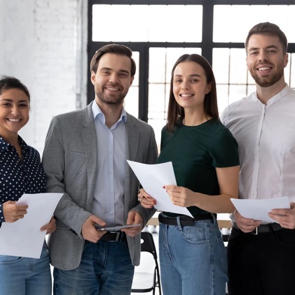 Group portrait of smiling diverse young multiethnic businesspeople posing together in modern office
