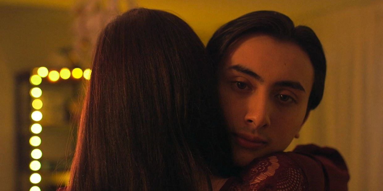 Two people sharing an intimate hug with warm lighting.