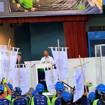 Participants with blue helmets at the Steam Maker Challenge in El Salvador.