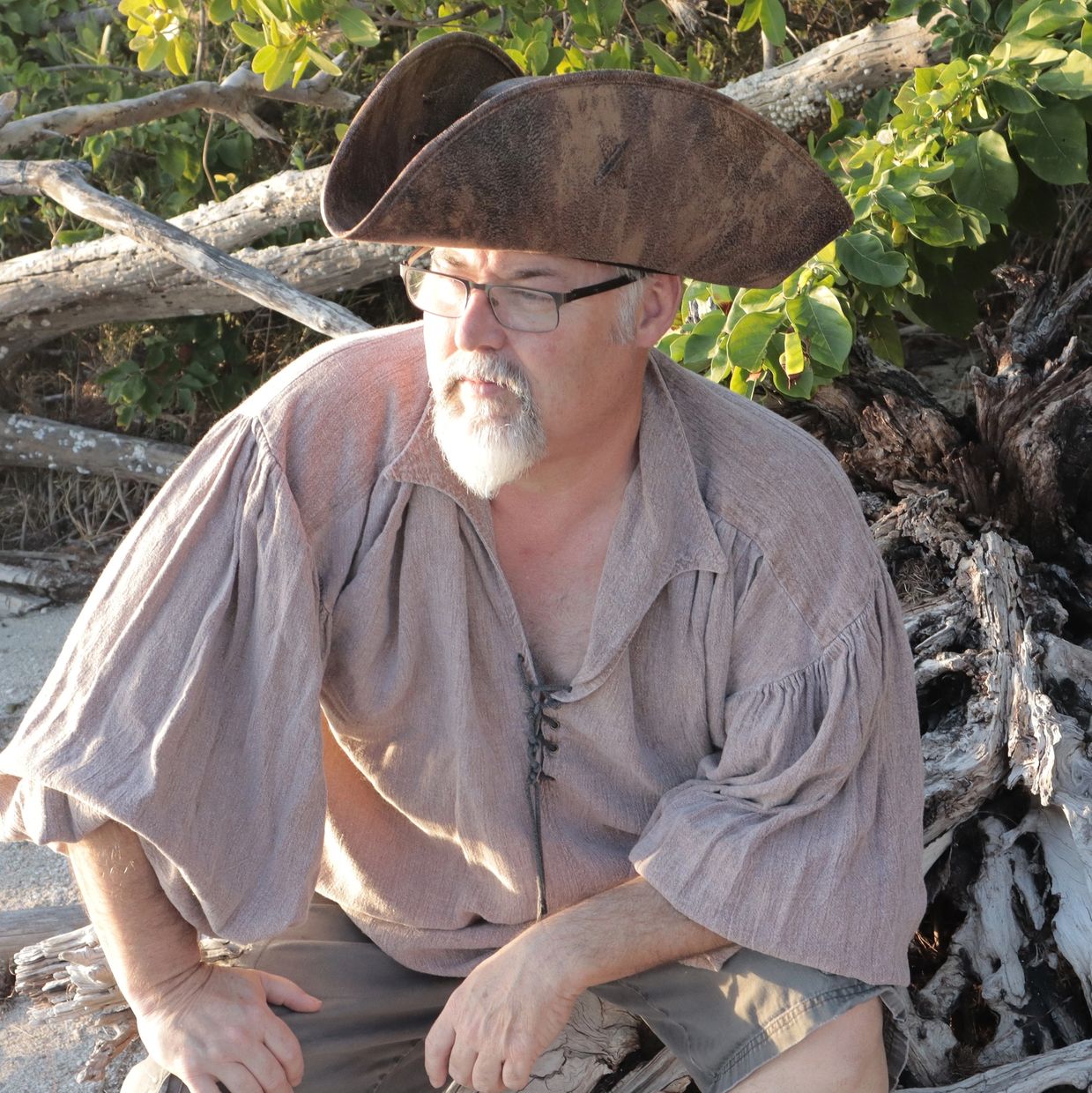 Wally T. Young near driftwood on a beach.