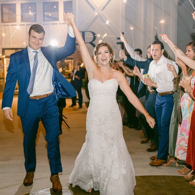 Newlyweds celebrating with sparklers and joyful smiles.