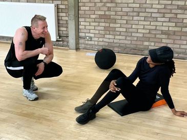 Trainer Russ chatting to member after completing a fitness class.