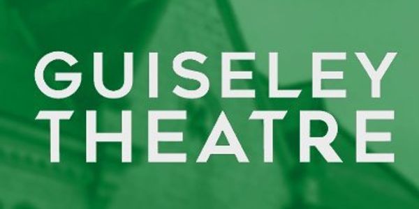 Sign for Guiseley Theatre in bold white letters on green background.