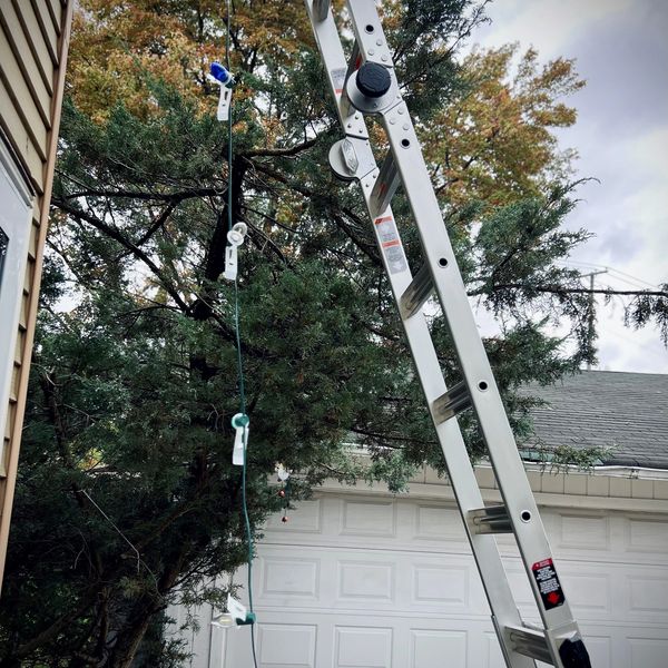 Christmas lights going up on a house