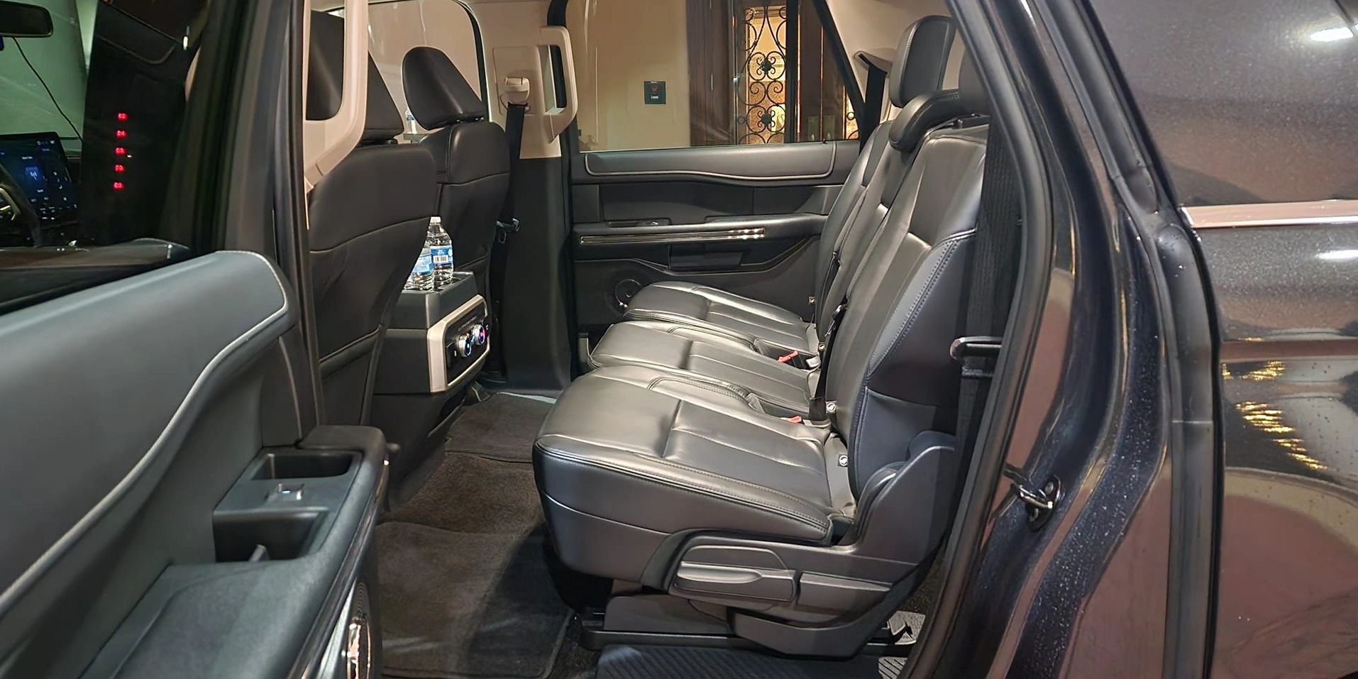 Spacious black leather back seats inside a modern vehicle.