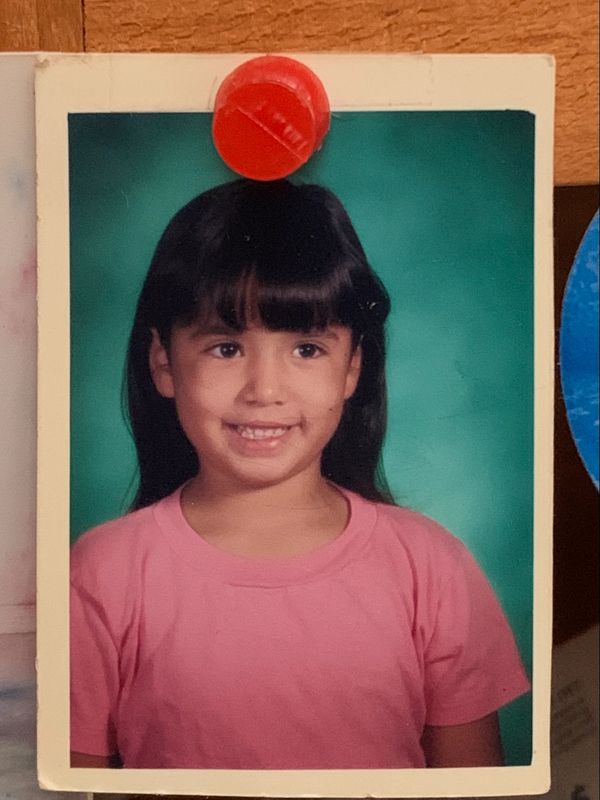 Kelsey wearing a pink shirt in first grade. 