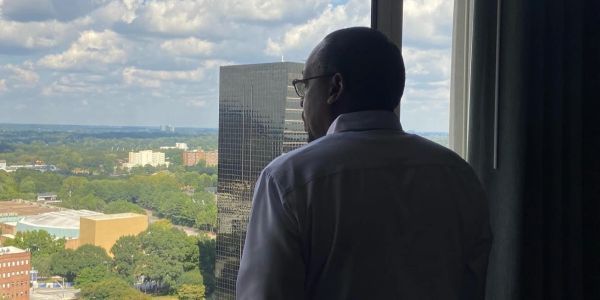 Man looking out from a high window.