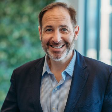 Smiling middle-aged man in a blazer.