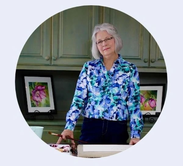 Older woman artist with watercolor paintings.