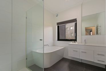 elegant white and grey bathroom, bath, vanity, taps, shower