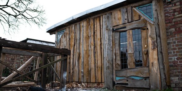 Garden workshop with rustic chestnut cladding and bespoke windows