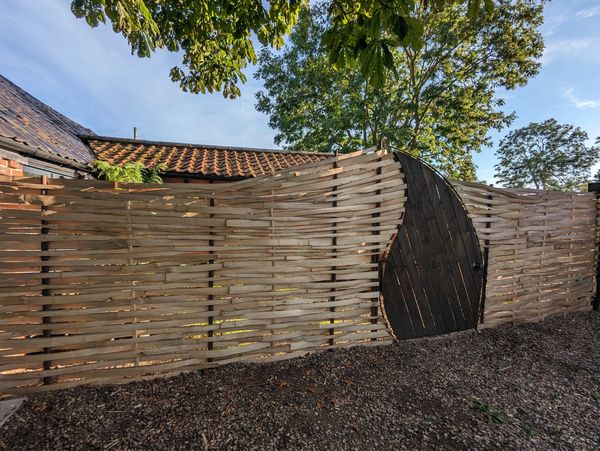 Flowing woven fence and bespoke gate