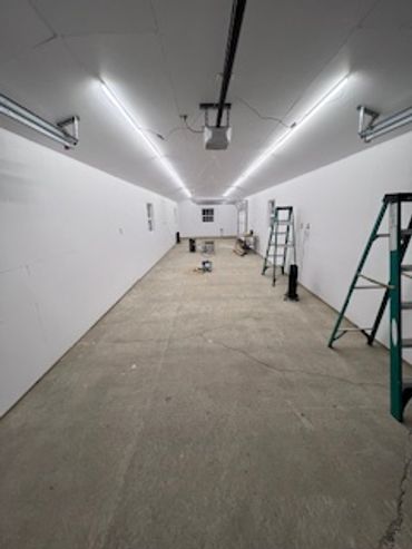 Closed in this insulated garage with zip board and painted it for a fresh light airy feel.