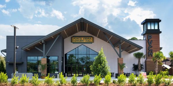 Ponte Vedra Concert Hall building with modern architecture under a partly cloudy sky.