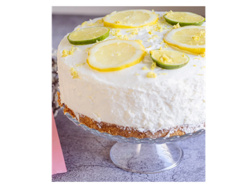 Lemon lime cheesecake on a glass stand.