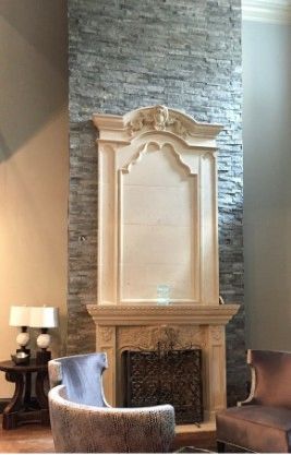Elegant fireplace with decorative mantel and stone background.
