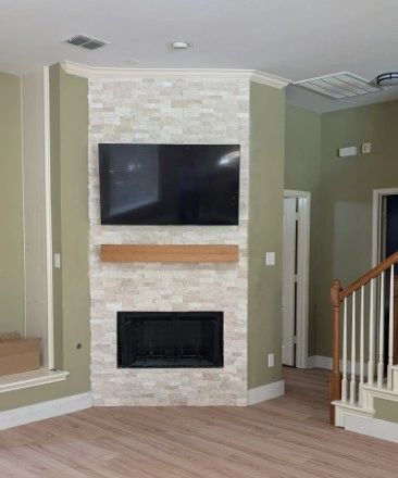 Modern living room with TV and fireplace.