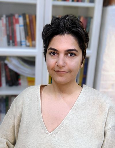 THE IMAGE SHOWS IDA NIKOU, IRANIAN QUEER LABOR SCHOLAR ACTIVIST, SHORT BROWN HAIR, BROWN EYES, WHITE